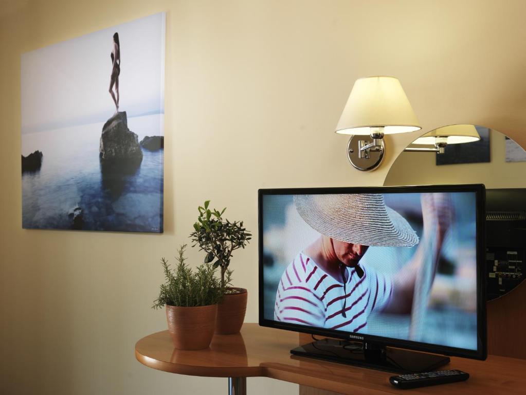 a flat screen tv sitting on top of a table at Hotel Neptun - Terme & Wellness Lifeclass in Portorož