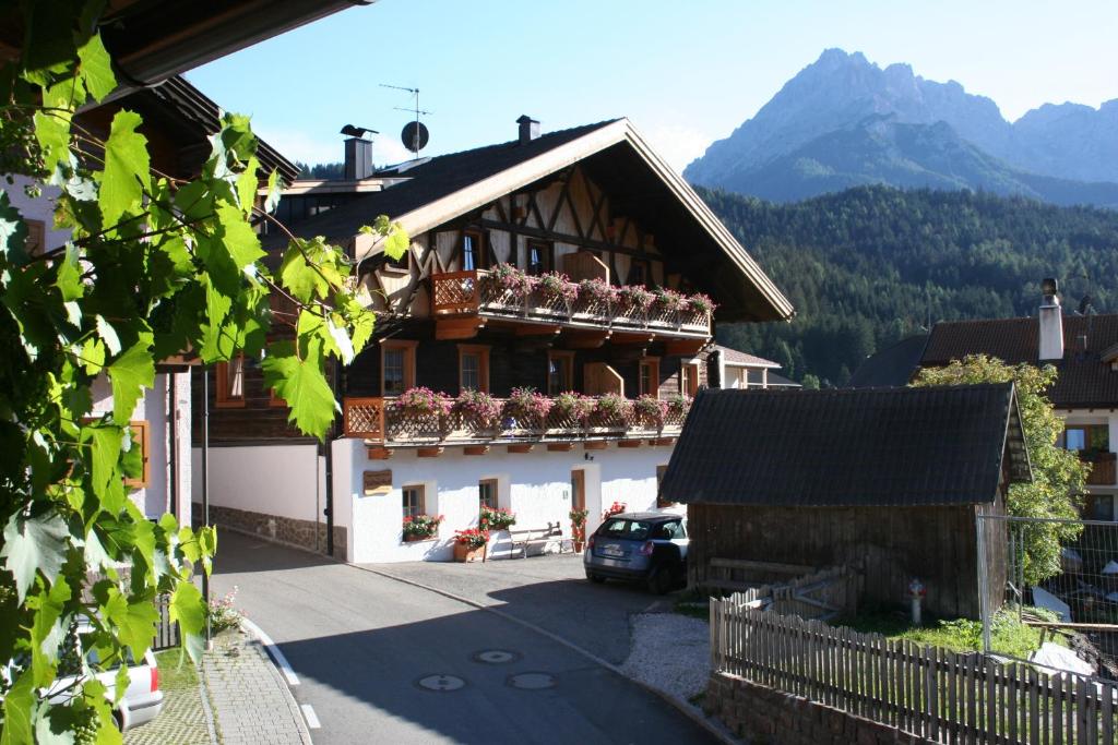 a building with potted plants on the balconies of it at Valtnerhof in San Candido