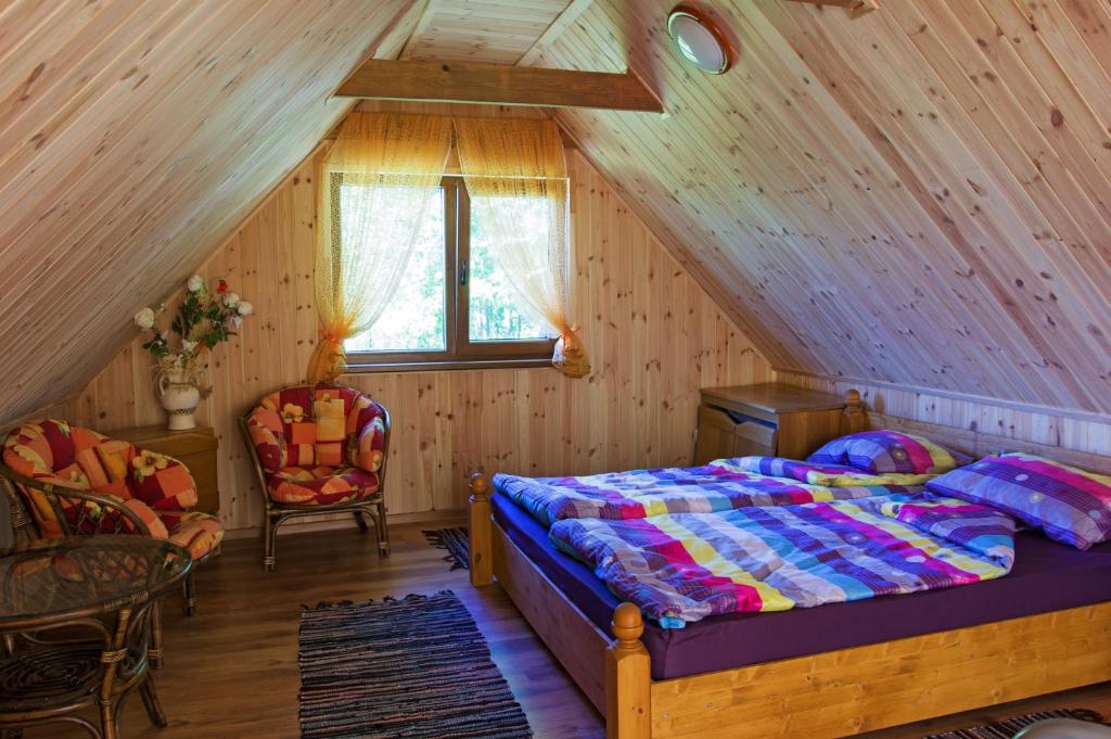 a bedroom with a bed in a attic at Grāveri kempings in Usma