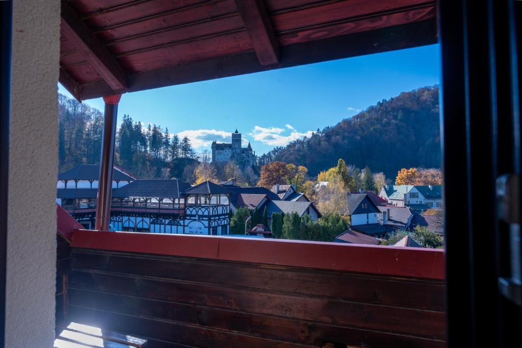 a view of a town from the balcony of a house at Casa Din Bran - Inn Cuisine in Bran