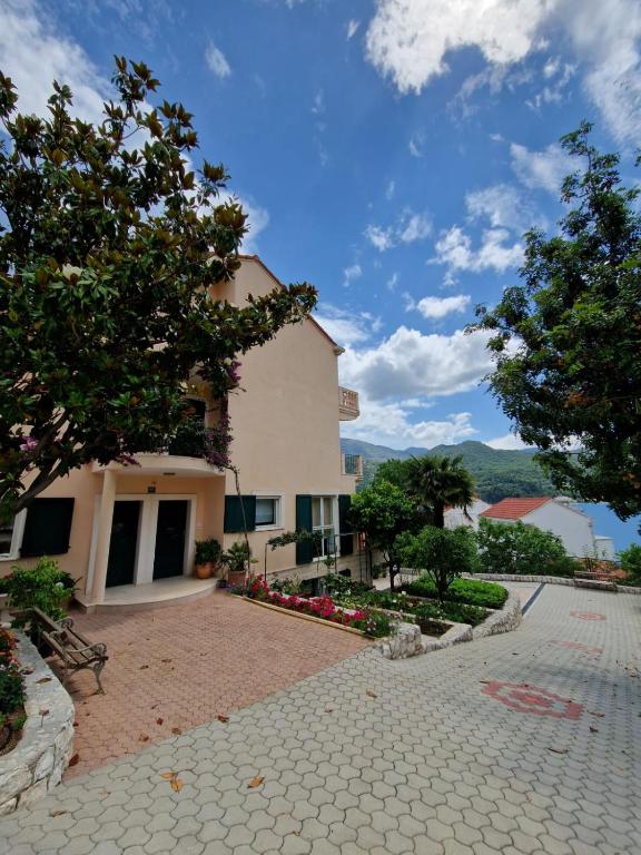 a building with trees and a stone walkway at Villa Sea Garden Slano in Slano