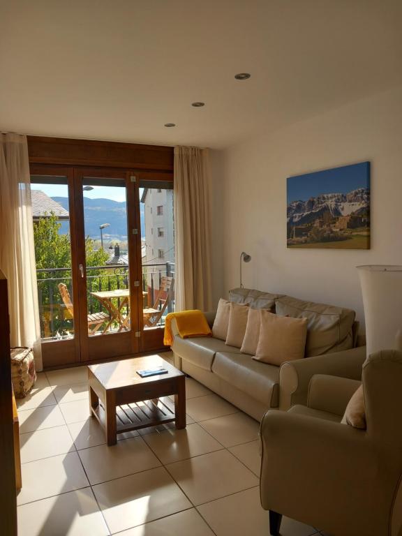 a living room with a couch and a table at Apartaments Bell-Lloc Puigcerda in Puigcerdà