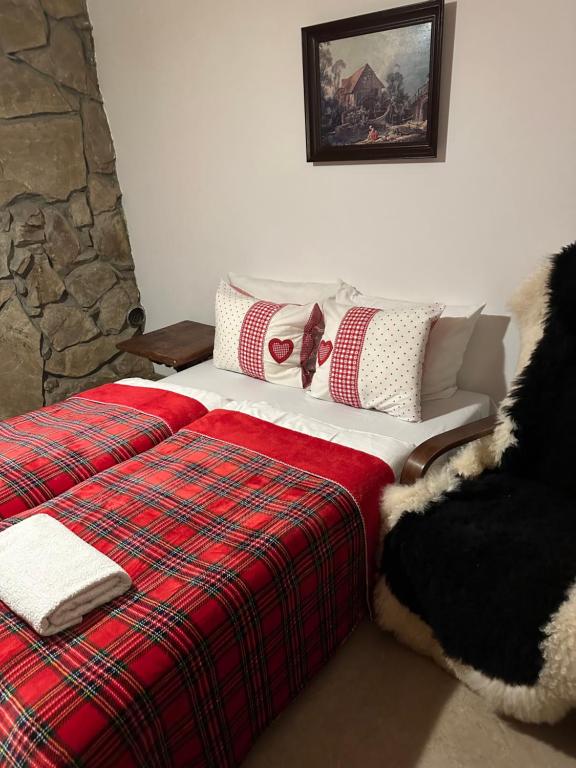 a bedroom with a bed with a plaid blanket at Mała Bawaria in Zakopane