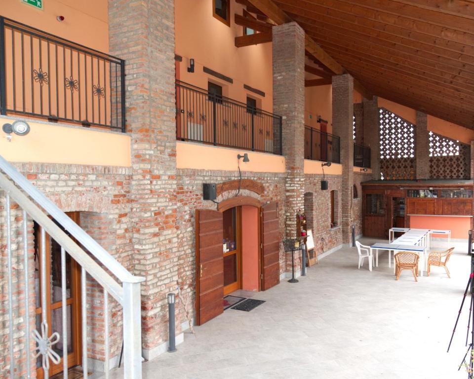 an outside view of a building with a patio at Cascina Amrit CAV in Borghetto Lodigiano