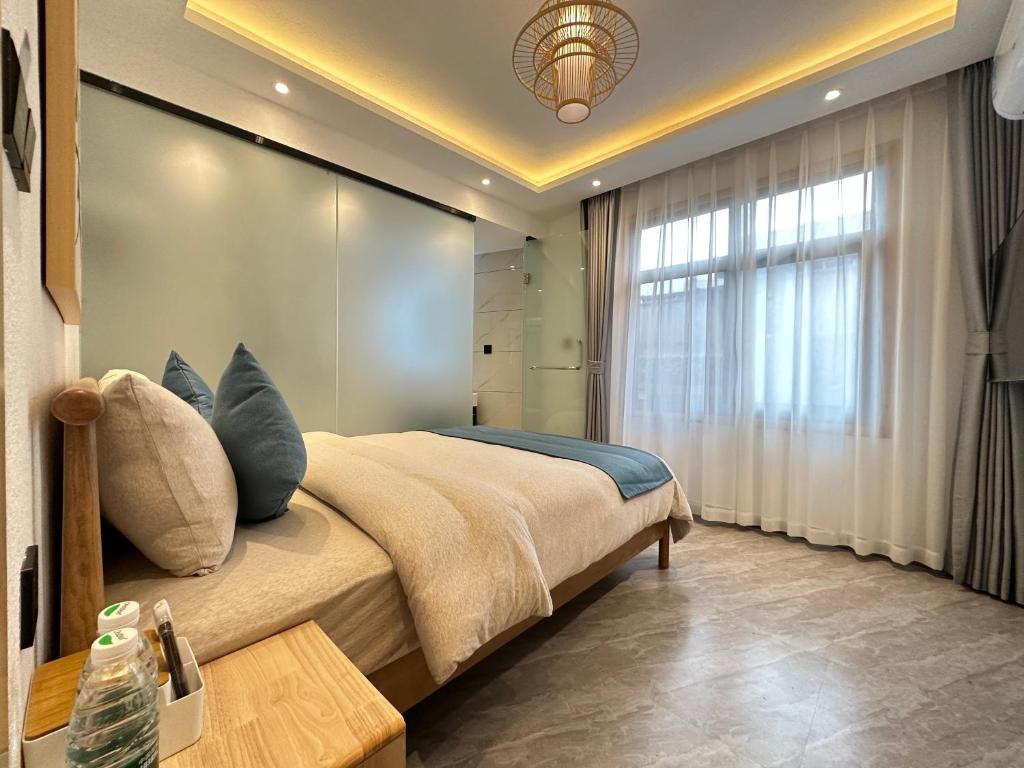 Postel nebo postele na pokoji v ubytování Yifangyan - Tingyuan Qingshe Hostel