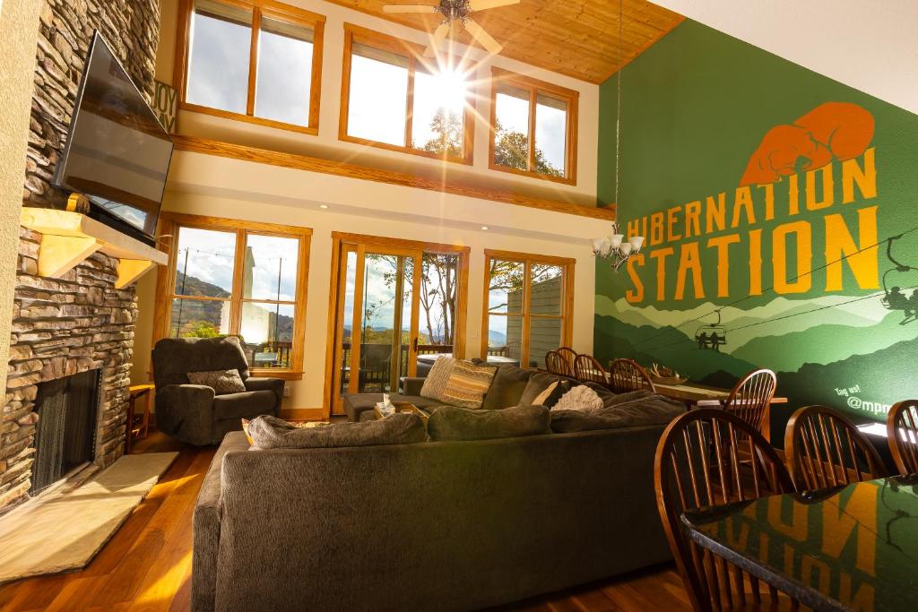 a living room with a couch and a fireplace at Hibernation Station - MTN Views near Asheville! in Swiss
