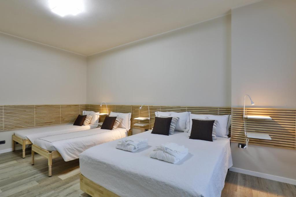 a bedroom with two beds and a window at DANTE SUITE in Como