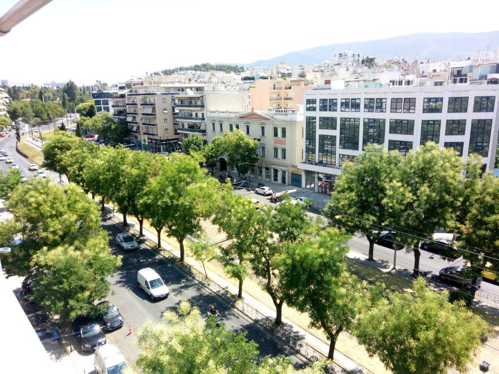 an overhead view of a street with trees and buildings at Acropolis penthouse with breathtaking city view in Athens