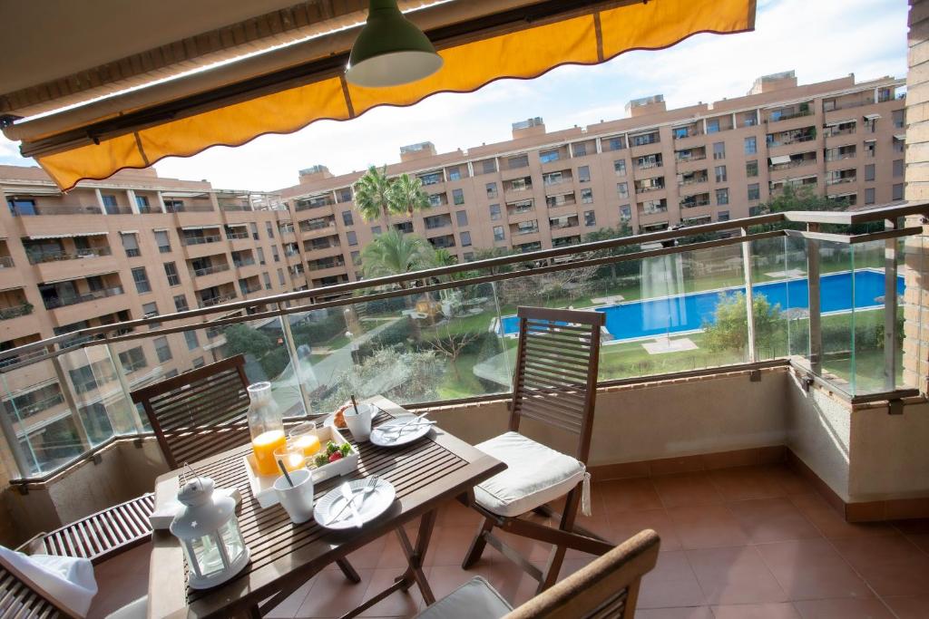 a balcony with a table and chairs and a view of a building at SingularStays Palacio de Congresos in Valencia