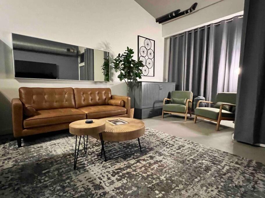 a living room with a couch and a table at San Diego Gaslamp Loft Getaway in San Diego