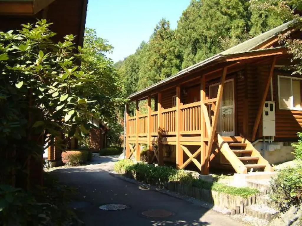 a log cabin with a porch and a driveway at Mori no Kuni - Vacation STAY 03842v in Ōma