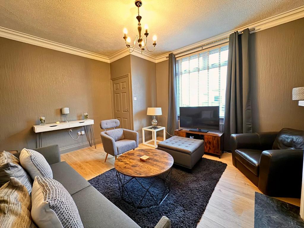 a living room with a couch and a table at The Woodlands - Zillo in Bishop Auckland