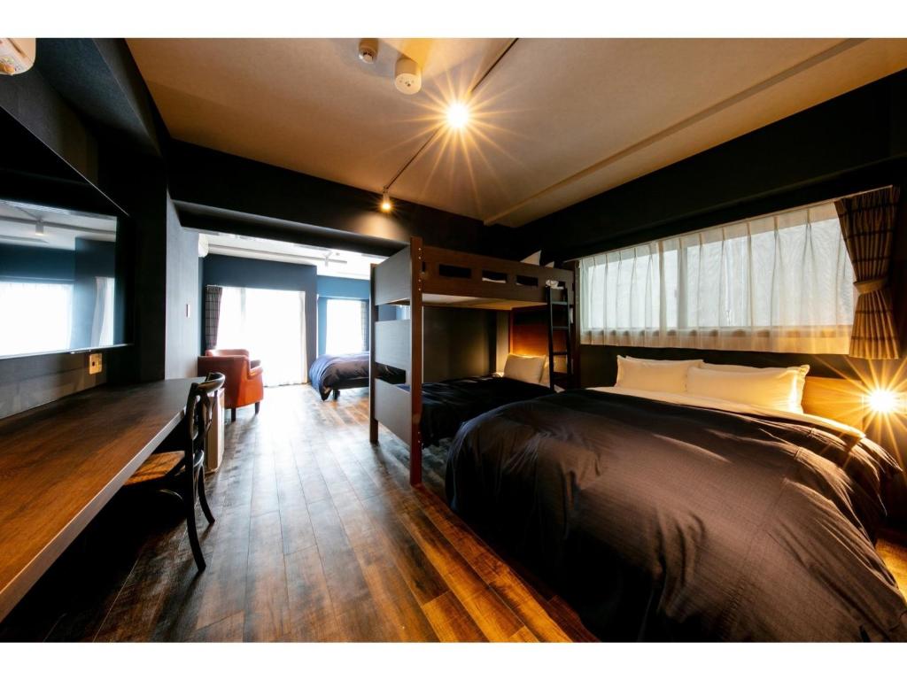 a bedroom with a large bed and a window at VILLA KOSHIDO ODORI - Vacation STAY 04750v in Sapporo