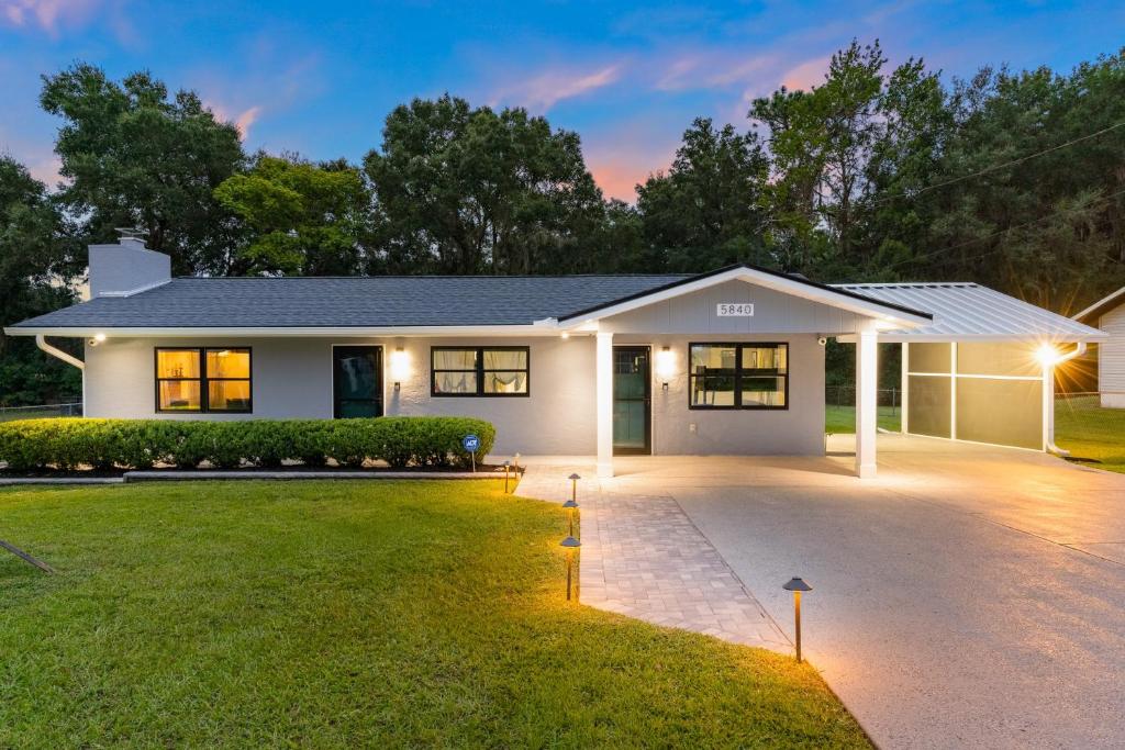 a white house with a driveway at A Ray of Turquoise in Belleview