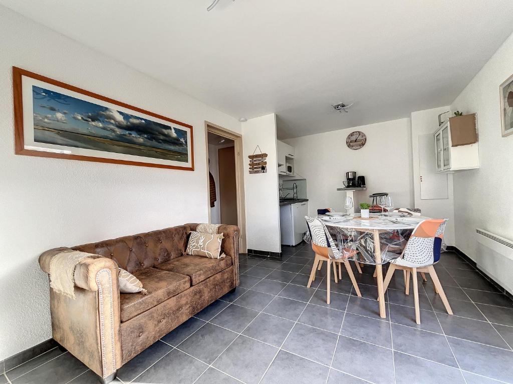 a living room with a couch and a table at Les Rêves du Crotoy in Le Crotoy