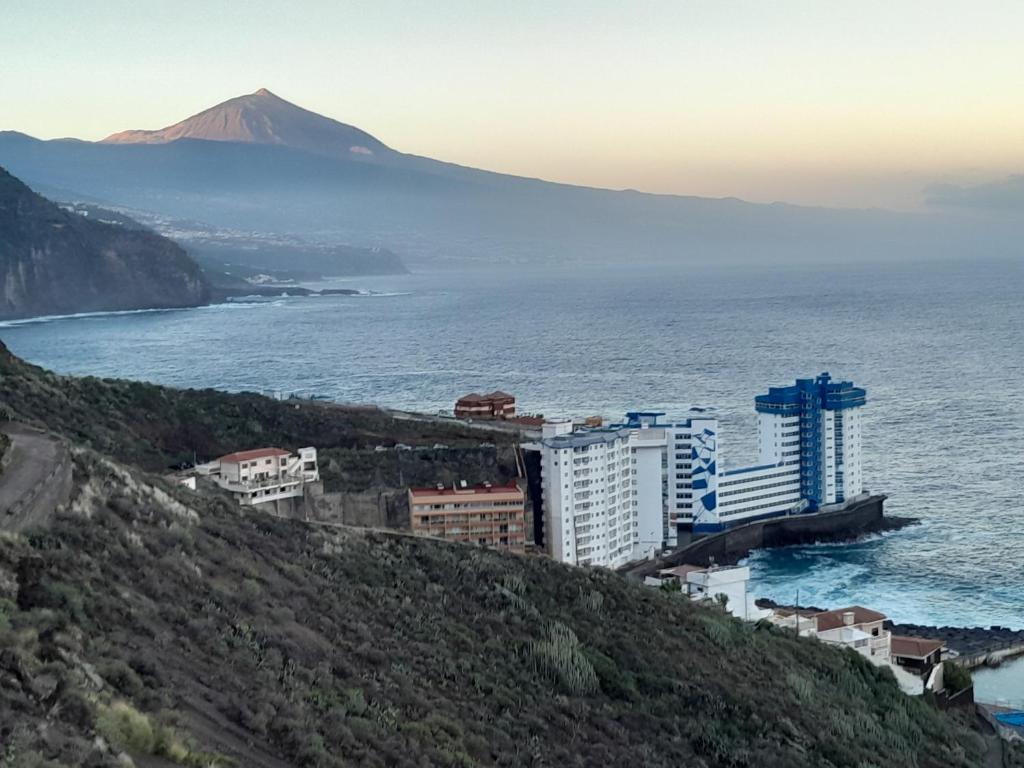 a group of buildings on a hill next to the ocean at Paraiso in Tacoronte