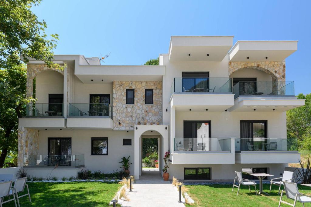 a villa with a view of the front of the house at Ammothines Beach Suites in Chrysi Ammoudia