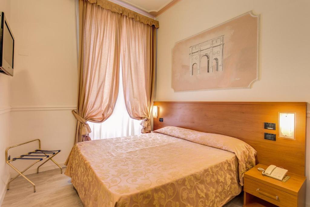 Postel nebo postele na pokoji v ubytování Hotel Martini