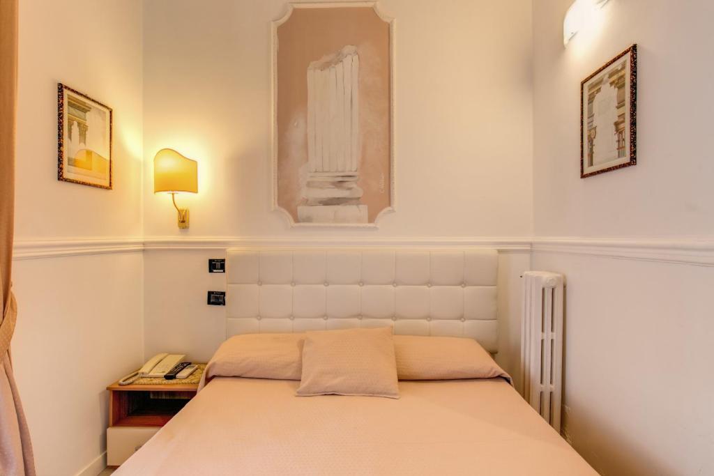 Postel nebo postele na pokoji v ubytování Hotel Martini
