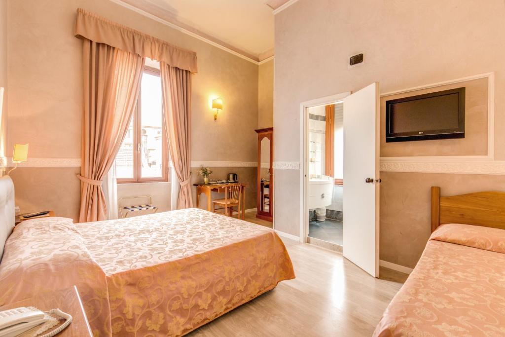 Postel nebo postele na pokoji v ubytování Hotel Martini