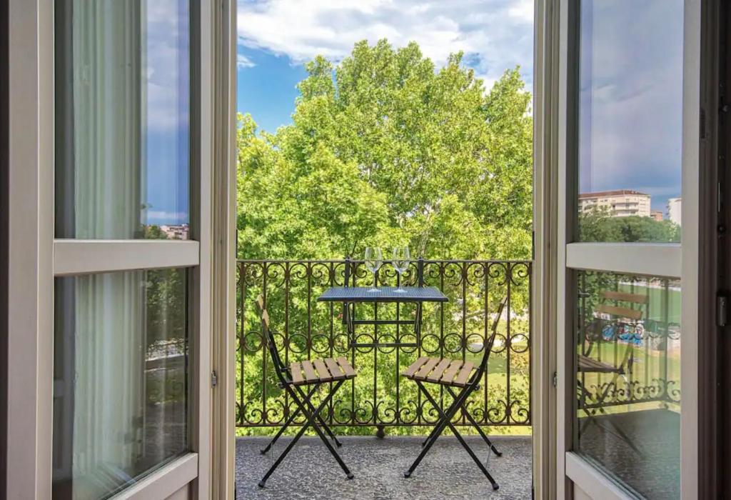 a view from a balcony with a table and chairs at Trilocale immerso nel verde in Turin