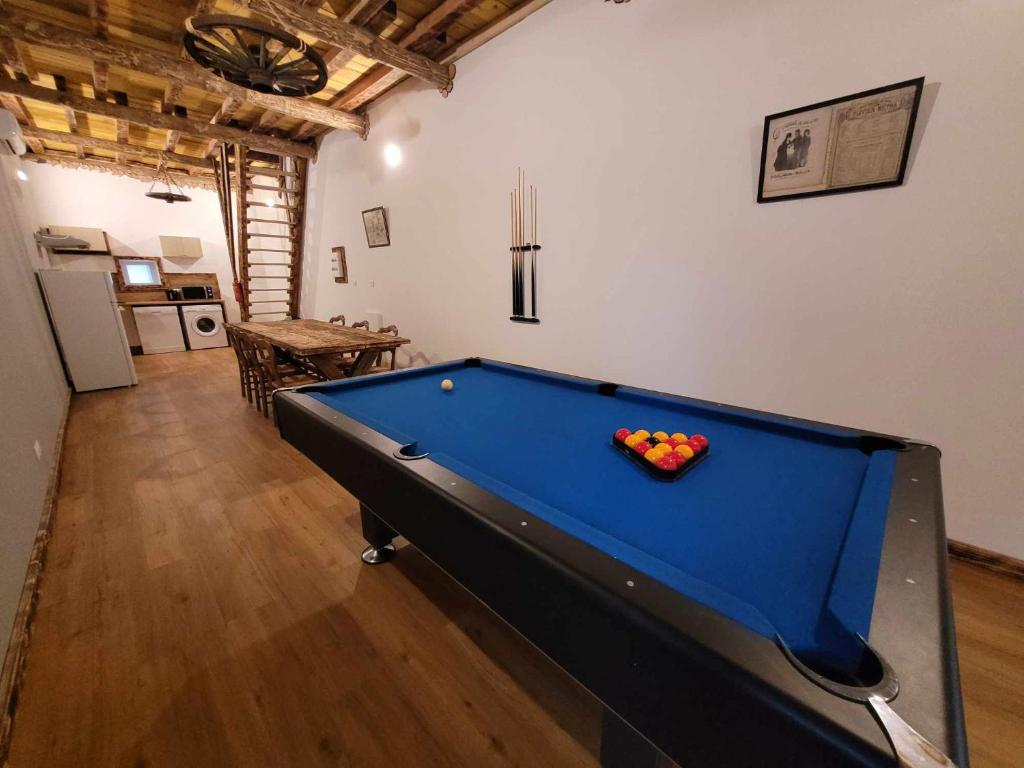 a pool table with a bowl of balls on it at Gîte de la Ferme de la Comté in Le Thillot