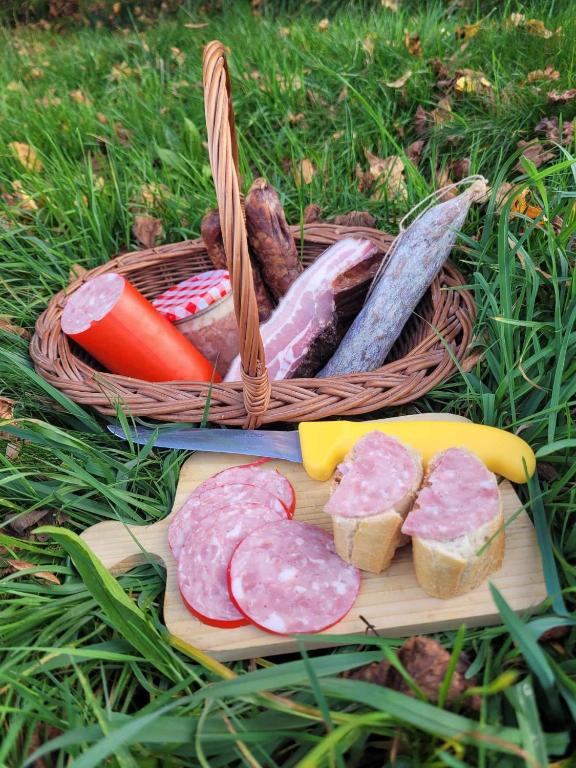 a basket of food with meat and bread and vegetables at Gîte de la Ferme de la Comté in Le Thillot