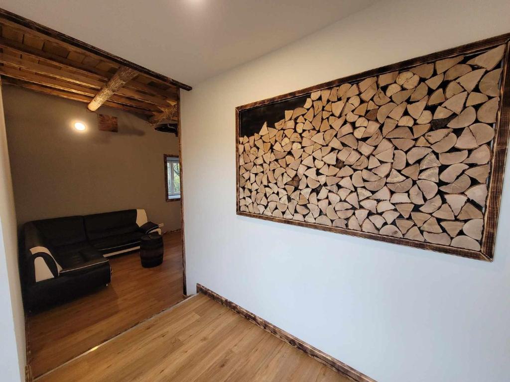 a room with a pile of fire wood on the wall at Gîte de la Ferme de la Comté in Le Thillot