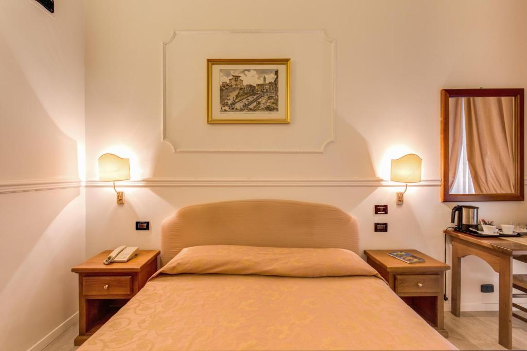 Postel nebo postele na pokoji v ubytování Hotel Martini