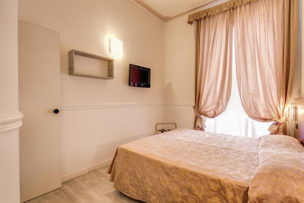 Postel nebo postele na pokoji v ubytování Hotel Martini