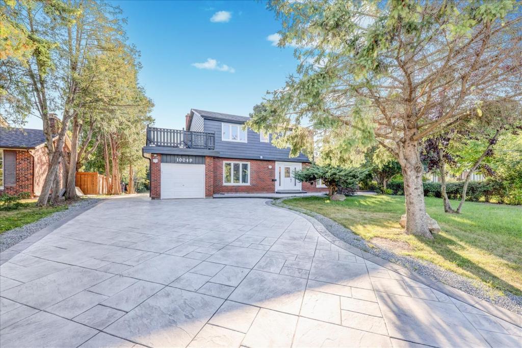 an empty driveway in front of a house at Stunning 7 Br House with 2-Kitchen, 5-Washroom & Amazing Backyard in Toronto