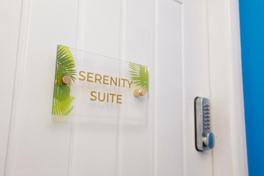 una puerta blanca con una señal de seguridad en ella en Harmony Haven - Serenity Suite en Nottingham