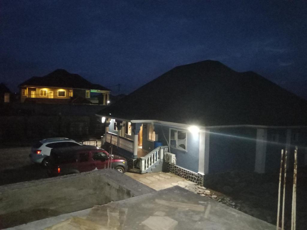 a house with a car parked in front of it at night at CIDMAT in Lakka