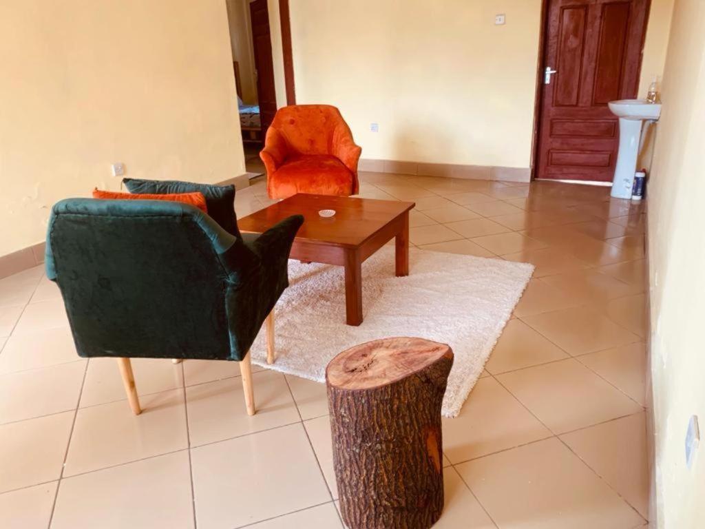 a living room with a couch and a table and a chair at Ukali ukalini homes in Sanya Juu