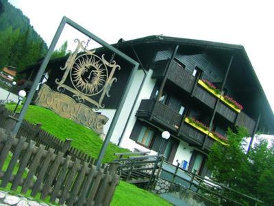 a building with a clock on the front of it at Residence Borgo al Sole in Sappada