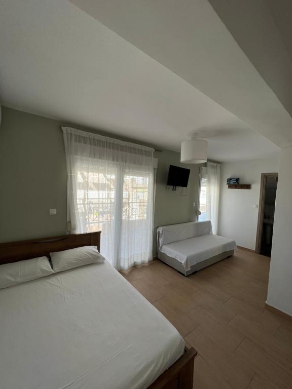 ein Schlafzimmer mit einem Bett und einem Sofa in der Unterkunft Happy Traveller SKG in Thessaloniki