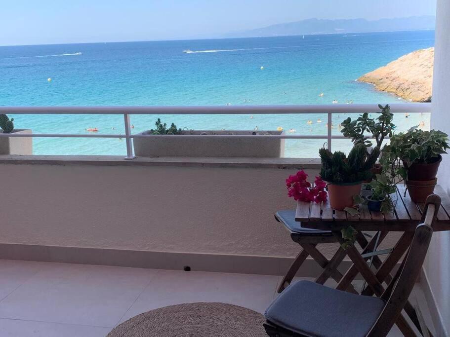 balcón con mesa y vistas al océano en Apartamento sobre el mar, en Salou