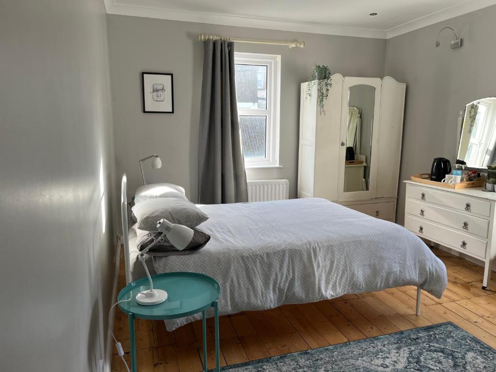 a bedroom with a bed and a table with a lamp at Loughview in Bangor