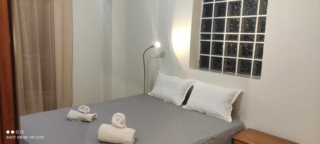 a bedroom with a bed with two towels on it at pylaia comfortable apartment 2 in Thessaloniki