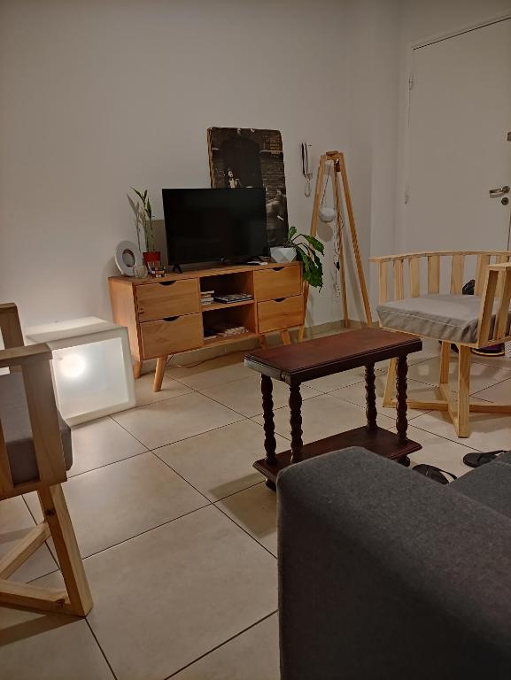 a living room with a tv on a wooden dresser at Bauhaus departamento centro in Córdoba