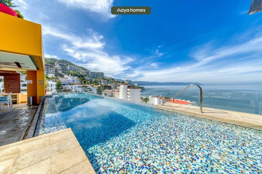a swimming pool on the roof of a building at Chic Studio w/Rooftop Pool - Ocean View - King Bed in Puerto Vallarta