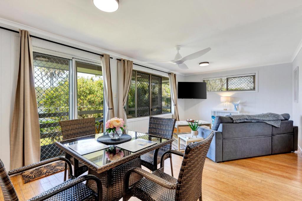 a living room with a table and chairs and a couch at Sanctuary Lakes Fauna Retreat in Hervey Bay
