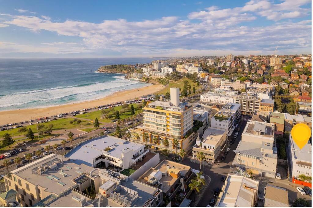 an aerial view of a city and the beach at 2B Beach Escape @ 89 Roscoe in Sydney
