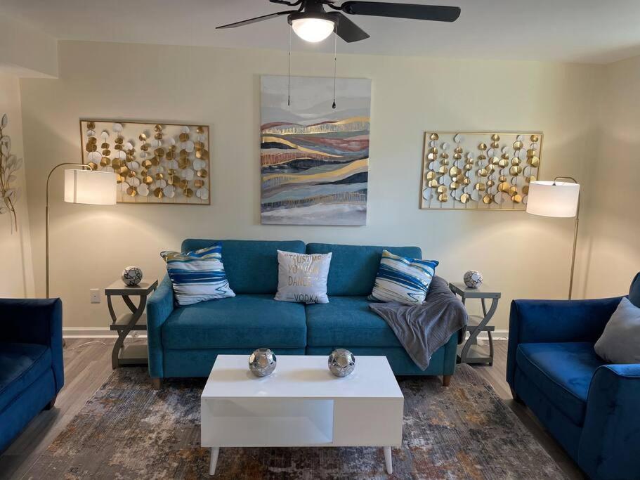 a living room with a blue couch and a table at Modern Wi-Fi, Pet friendly home for Families in Greenville