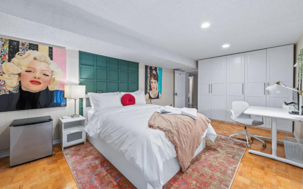 a bedroom with a large white bed and a desk at Spacious bedroom with garden view, fridge, workspace in Toronto