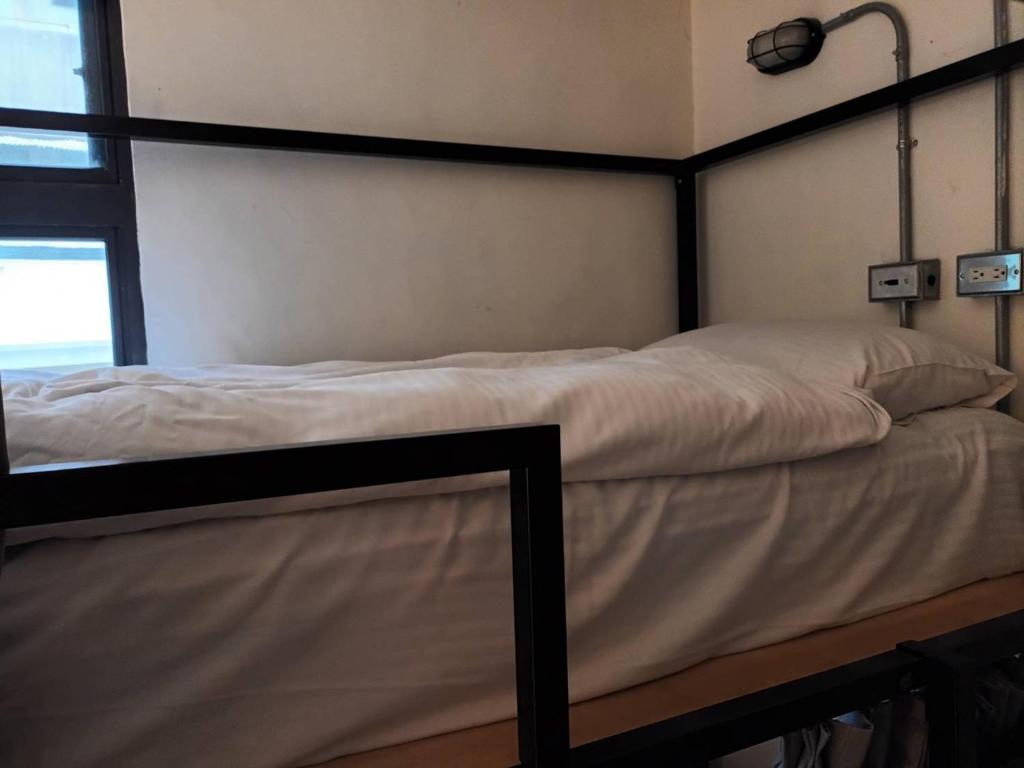 Postel nebo postele na pokoji v ubytování 薇薇青旅-嚞驫驛站
