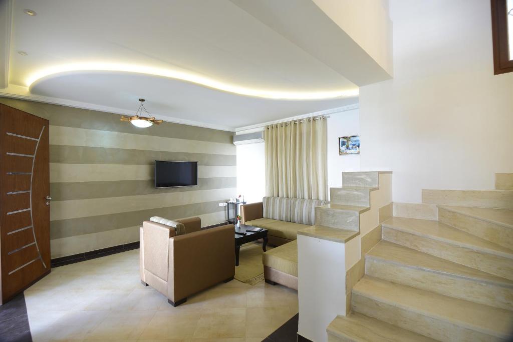a lobby with a staircase and a waiting room at Palm Djerba Suites in Mezraya