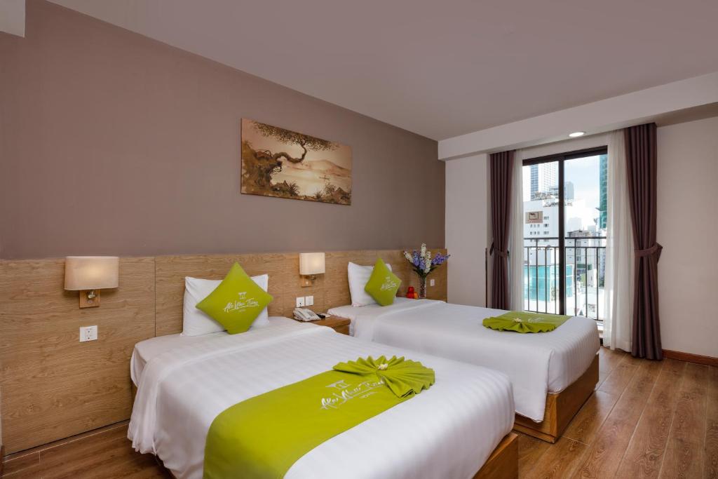 Giường trong phòng chung tại Ale Nha Trang Hotel