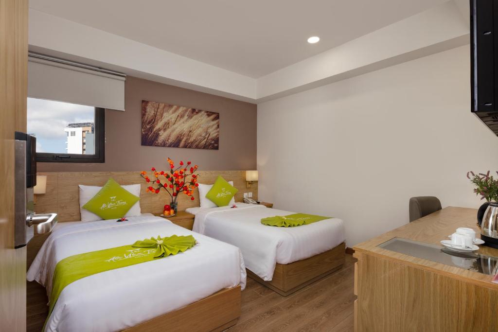 Giường trong phòng chung tại Ale Nha Trang Hotel