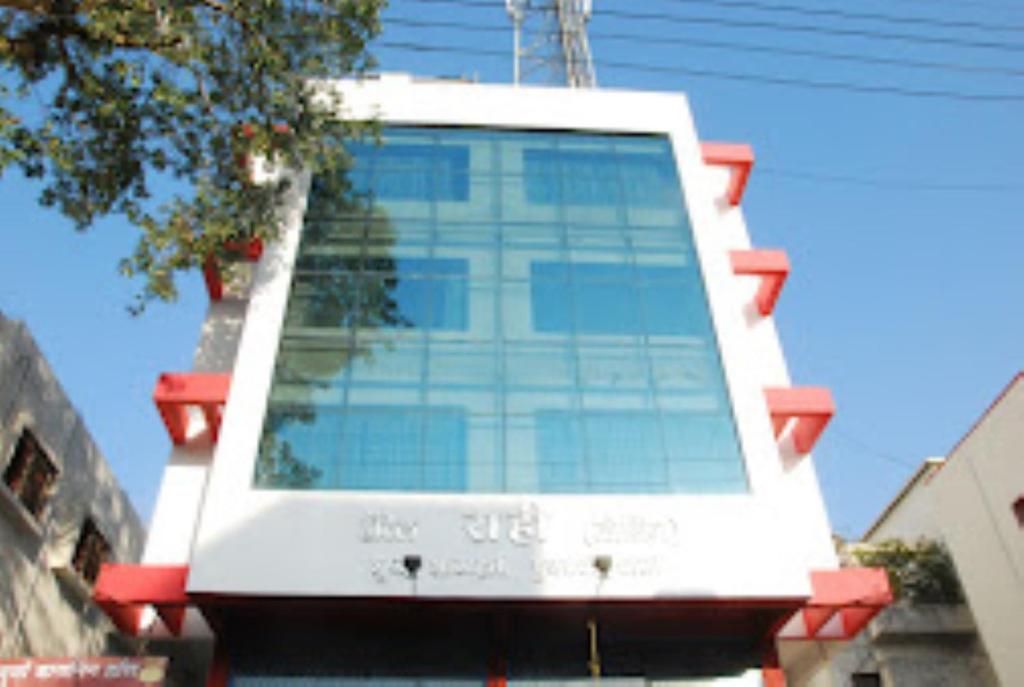 a building with a large window on the side of it at Hotel Rahi,Nashik in Nashik